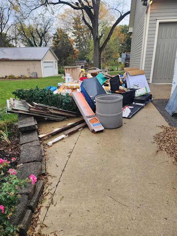 Dumpster being loaded with debris for Residential Dumpster Rental in South Russell